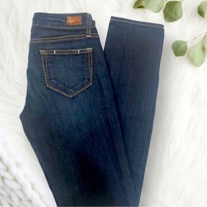 Paige Premium Denim. “Peg Skinny” jeans in dark wash.